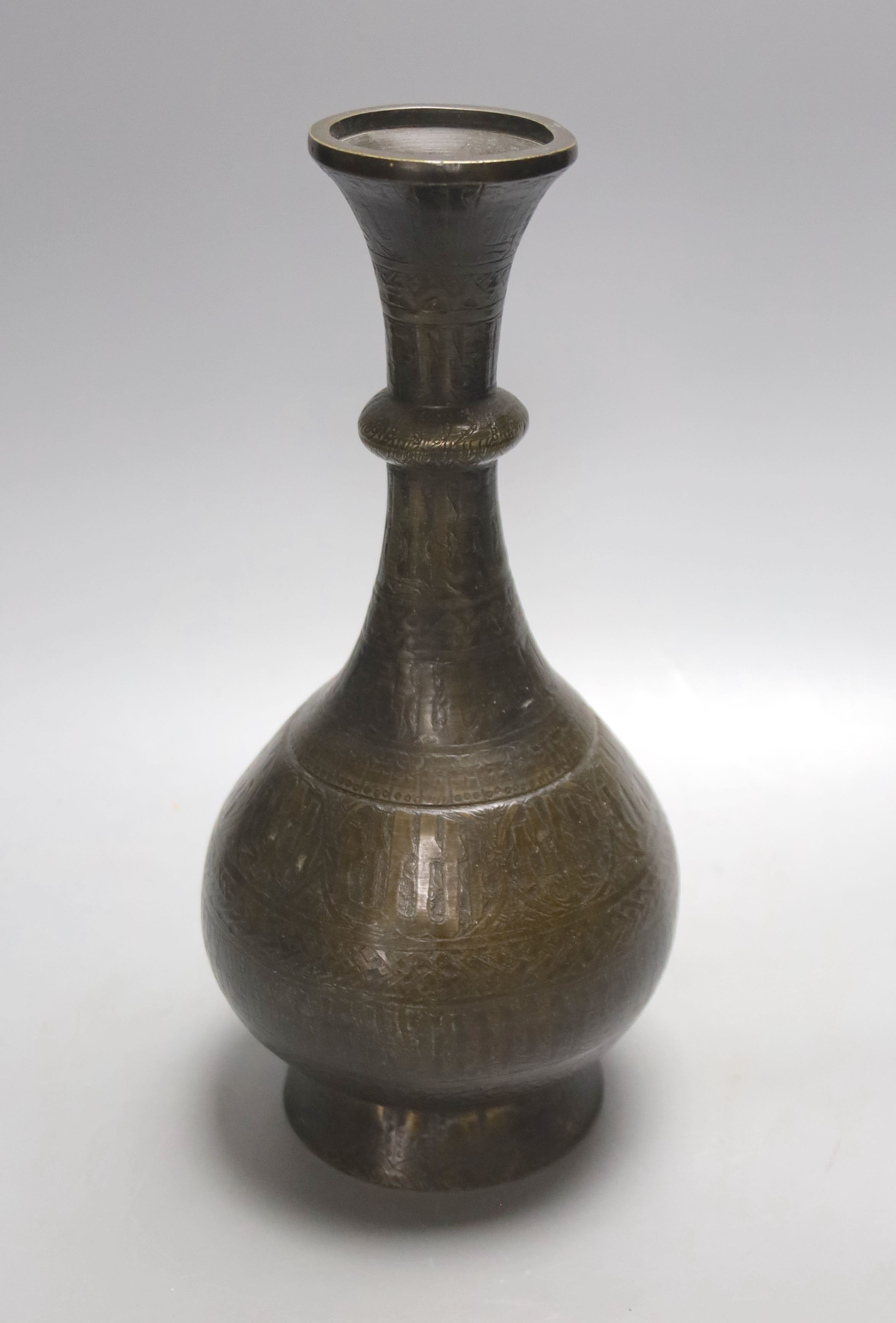 A Middle Eastern Islamic bronze vase, 28 cms high.